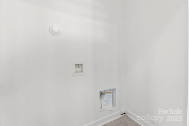 washroom with baseboards, laundry area, washer hookup, and wood finished floors