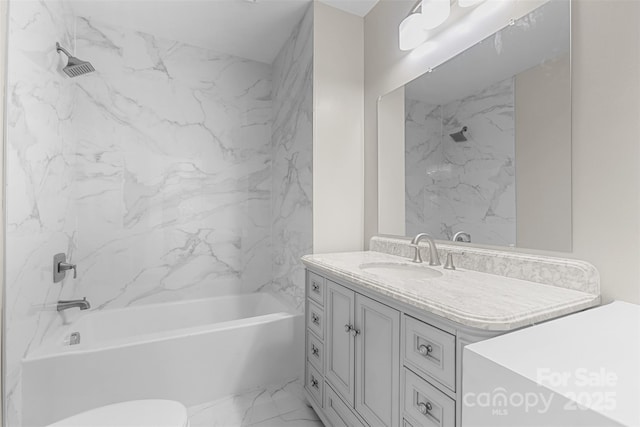 bathroom featuring toilet, bathing tub / shower combination, marble finish floor, and vanity