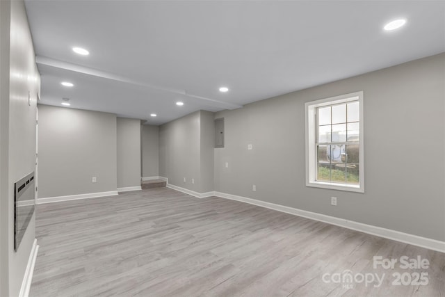 below grade area featuring light wood-type flooring, recessed lighting, and baseboards