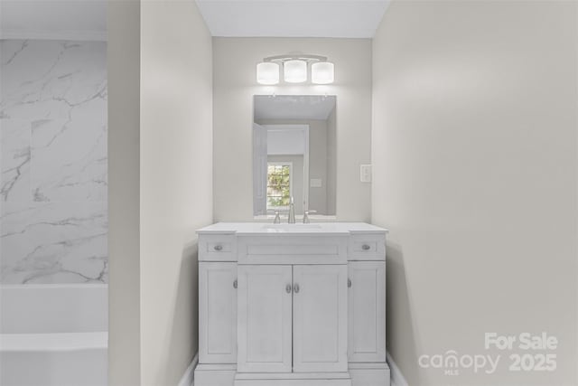 full bath featuring baseboards, marble finish floor, and vanity
