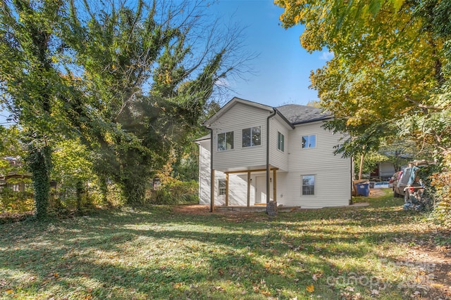 back of property featuring a patio area and a yard