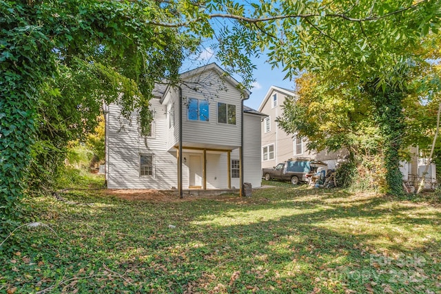 rear view of house with a lawn