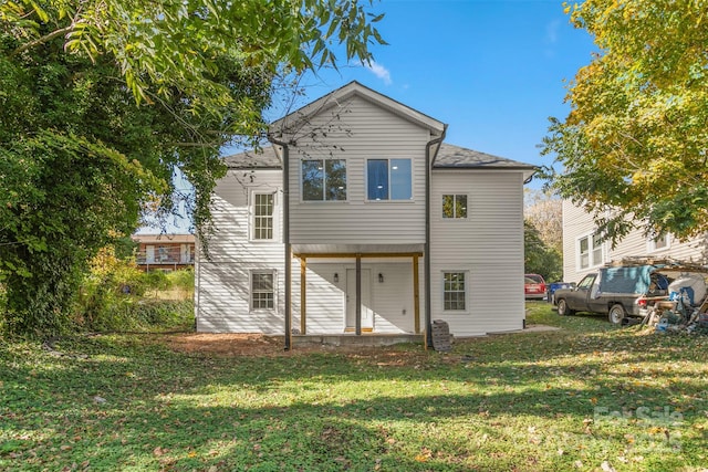 rear view of property with a lawn