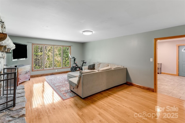living area with light wood-style floors and baseboards