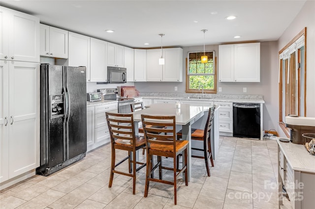 kitchen featuring recessed lighting, a sink, black appliances, and light countertops