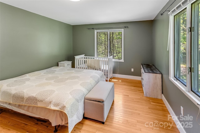 bedroom featuring baseboards and light wood-style floors