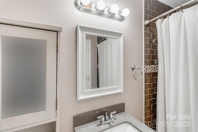 bathroom featuring a sink and a shower with curtain