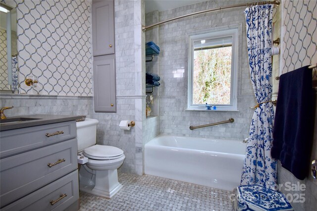 185 Macon Ave Unit 9B, Asheville, NC 28804 - bathroom featuring a bath, tile walls, toilet, vanity, and tile patterned flooring