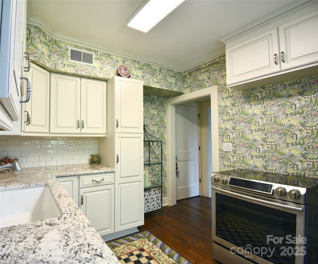 185 Macon Ave Unit 9B, Asheville, NC 28804 - kitchen featuring stainless steel electric range, wallpapered walls, ornamental molding, dark wood-style flooring, and backsplash