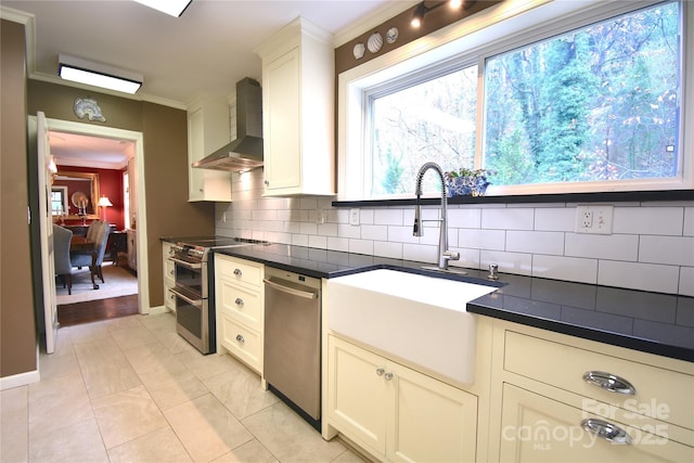 185 Macon Ave Unit 10B, Asheville, NC 28804 - kitchen with a sink, wall chimney exhaust hood, crown molding, appliances with stainless steel finishes, and decorative backsplash