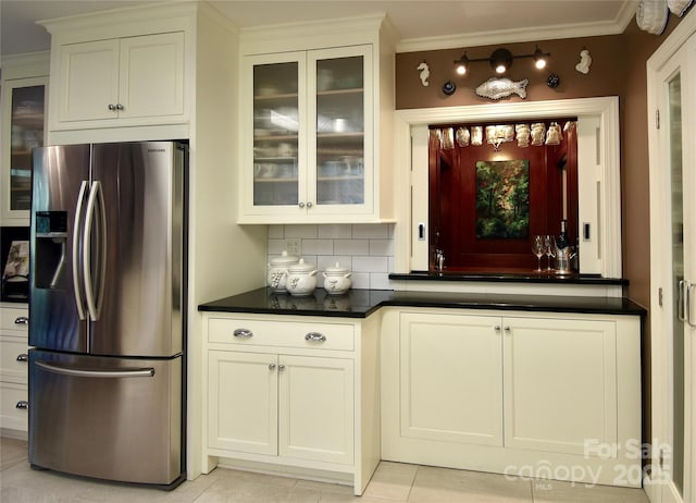 185 Macon Ave Unit 10B, Asheville, NC 28804 - bar featuring ornamental molding, backsplash, stainless steel fridge with ice dispenser, and light tile patterned floors