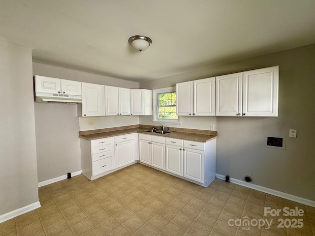 2020 Longleaf Dr, Charlotte, NC 28210 - kitchen featuring under cabinet range hood, white cabinetry, and dark countertops