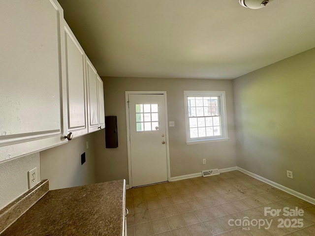 2020 Longleaf Dr, Charlotte, NC 28210 - laundry room with cabinet space, light tile patterned floors, and electric dryer hookup