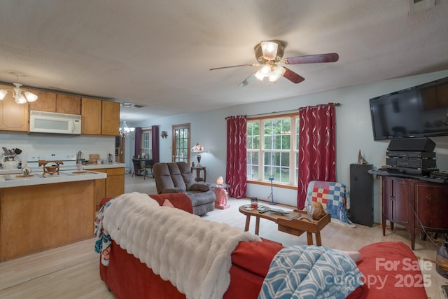 857 Hills Rd, Belmont, NC 28012 - living room with visible vents, ceiling fan with notable chandelier, and light wood-style floors