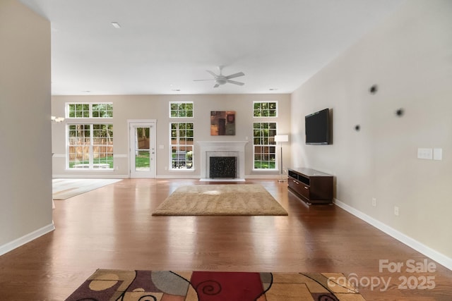 12013 Regent Ridge Ln, Charlotte, NC 28278 - unfurnished living room with ceiling fan, wood finished floors, and plenty of natural light