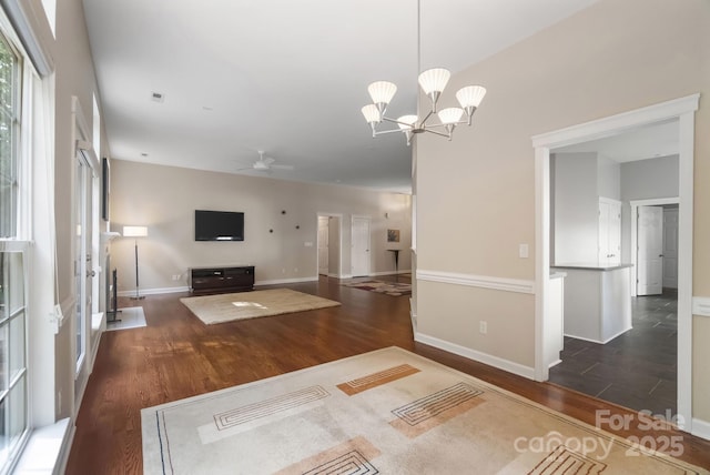 12013 Regent Ridge Ln, Charlotte, NC 28278 - unfurnished living room featuring wood finished floors, baseboards, ceiling fan, and a chandelier