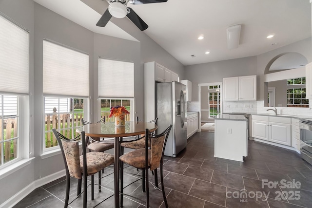 12013 Regent Ridge Ln, Charlotte, NC 28278 - kitchen with stainless steel fridge, white cabinets, plenty of natural light, and recessed lighting