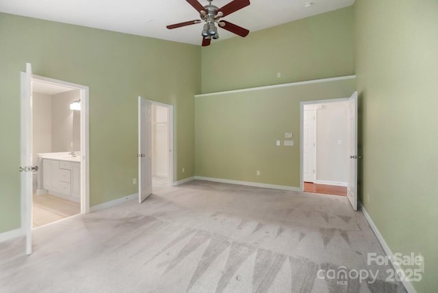 12013 Regent Ridge Ln, Charlotte, NC 28278 - unfurnished bedroom featuring a high ceiling, light carpet, connected bathroom, and baseboards