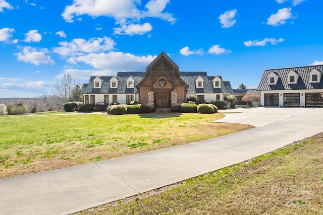 12613B Oak Grove Rd, Stanfield, NC 28163 - view of front of property with a front yard, concrete driveway, a standing seam roof, stone siding, and metal roof