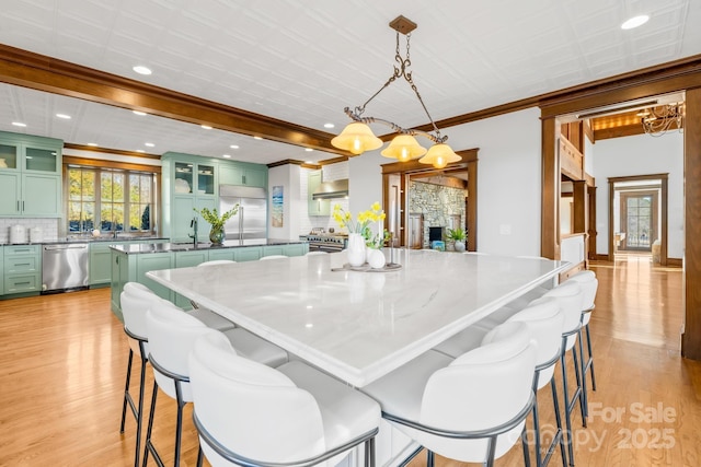 12613B Oak Grove Rd, Stanfield, NC 28163 - dining area featuring light wood-style floors, crown molding, a chandelier, recessed lighting, and a stone fireplace