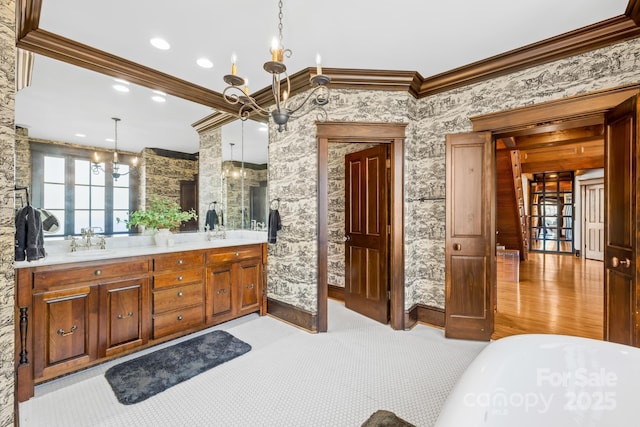 12613B Oak Grove Rd, Stanfield, NC 28163 - full bath with ornamental molding, a chandelier, a freestanding tub, double vanity, and wallpapered walls