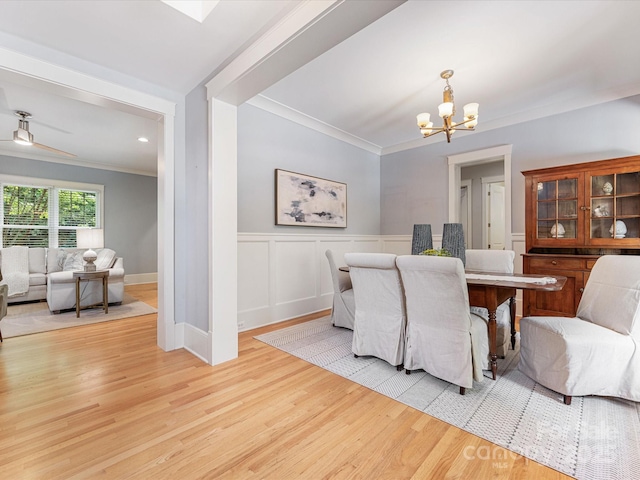 3825 Mountain Cove Dr, Charlotte, NC 28216 - dining area featuring ornamental molding, a chandelier, wood finished floors, and a wainscoted wall