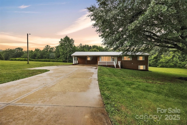 133 Jo Monni Loop, Statesville, NC 28625 - ranch-style home featuring driveway, a yard, metal roof, and covered porch