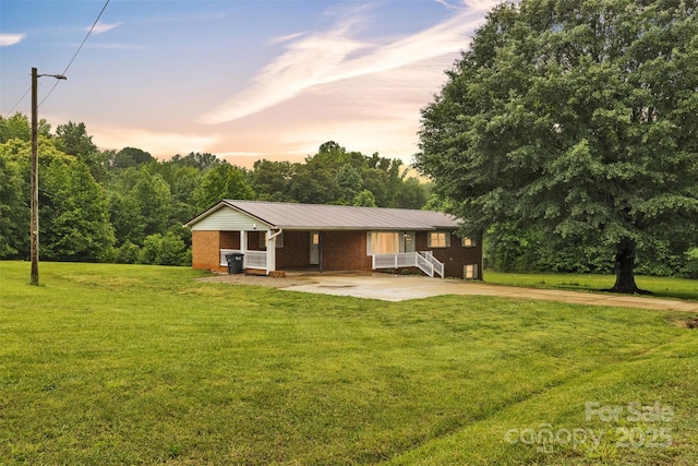 133 Jo Monni Loop, Statesville, NC 28625 - single story home with concrete driveway, metal roof, a lawn, and brick siding