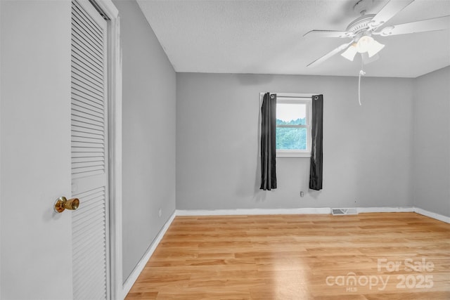 133 Jo Monni Loop, Statesville, NC 28625 - unfurnished bedroom featuring baseboards, wood finished floors, ceiling fan, and a textured ceiling