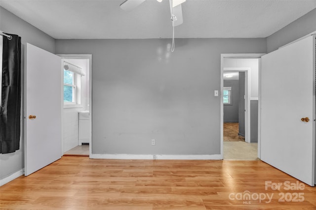 133 Jo Monni Loop, Statesville, NC 28625 - unfurnished bedroom with multiple windows, light wood-style flooring, and baseboards