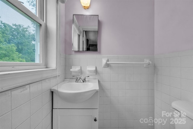 133 Jo Monni Loop, Statesville, NC 28625 - bathroom with vanity, healthy amount of natural light, tile walls, a wainscoted wall, and toilet