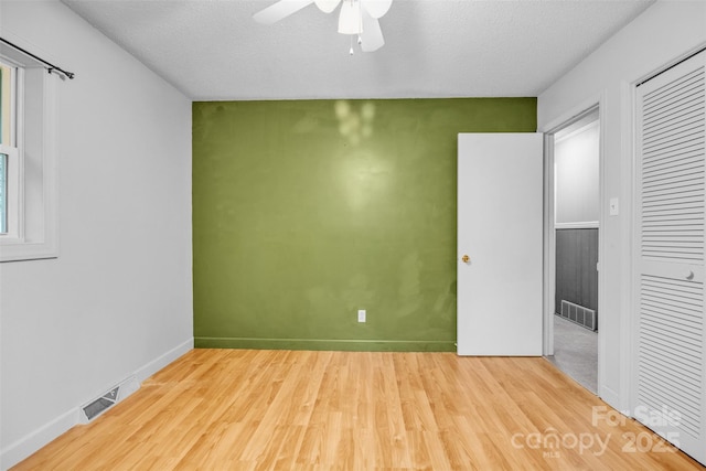 133 Jo Monni Loop, Statesville, NC 28625 - unfurnished room with ceiling fan, wood finished floors, a textured ceiling, and baseboards