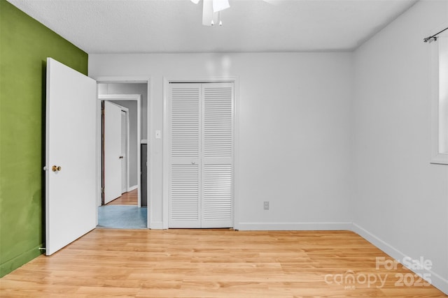 133 Jo Monni Loop, Statesville, NC 28625 - unfurnished bedroom with a closet, light wood-type flooring, ceiling fan, and baseboards