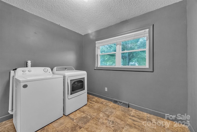 133 Jo Monni Loop, Statesville, NC 28625 - laundry room with washer and clothes dryer, a textured ceiling, and baseboards