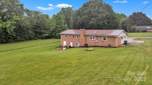133 Jo Monni Loop, Statesville, NC 28625 - view of side of property with brick siding, a yard, metal roof, and a chimney