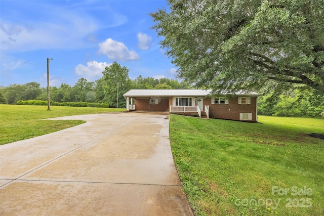 133 Jo Monni Loop, Statesville, NC 28625 - ranch-style home featuring concrete driveway, a front lawn, covered porch, metal roof, and a carport
