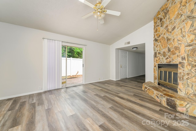 7129 Stonington Ln, Charlotte, NC 28227 - unfurnished living room with wood finished floors, a ceiling fan, a fireplace, baseboards, and high vaulted ceiling