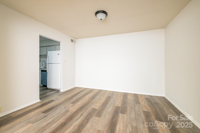 7129 Stonington Ln, Charlotte, NC 28227 - spare room with dark wood-style flooring, baseboards, and a sink