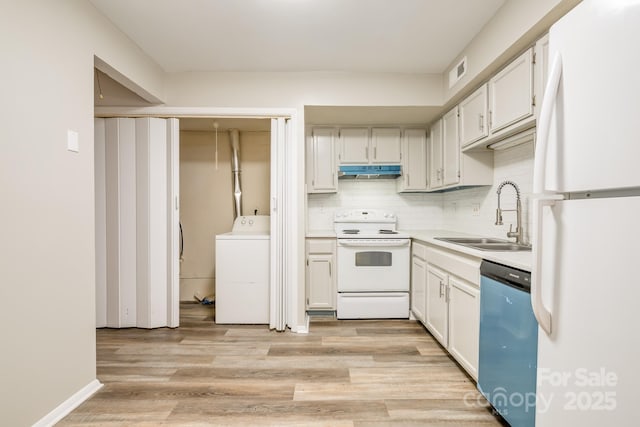 7129 Stonington Ln, Charlotte, NC 28227 - kitchen featuring white appliances, a sink, washer / dryer, under cabinet range hood, and light wood finished floors