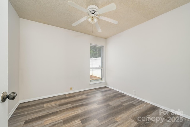 7129 Stonington Ln, Charlotte, NC 28227 - empty room with dark wood finished floors, a textured ceiling, a ceiling fan, and baseboards