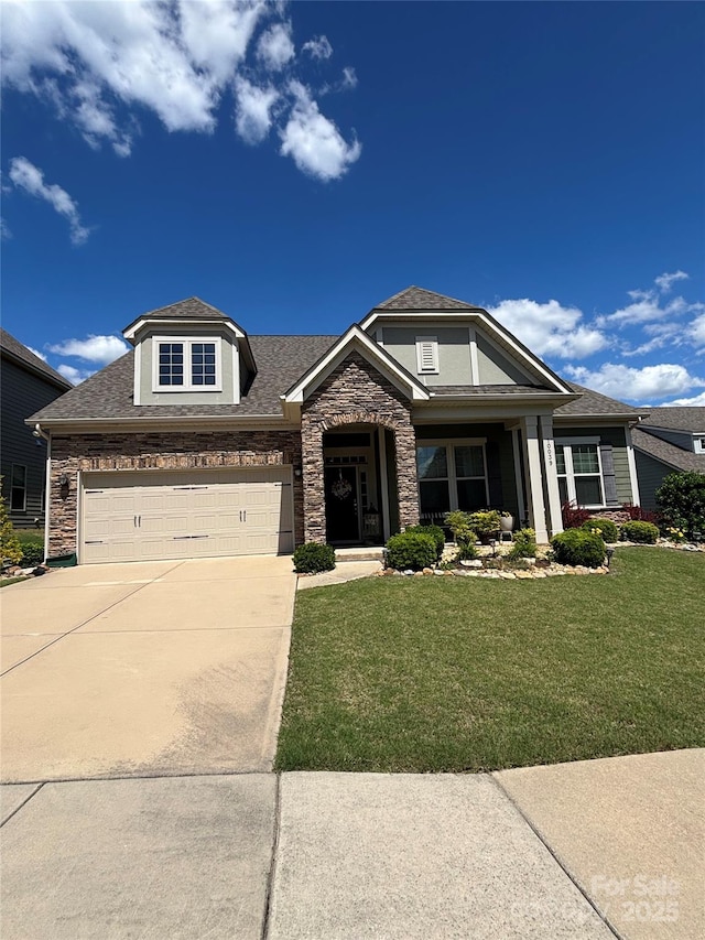 craftsman house with stone siding, driveway, and a front lawn