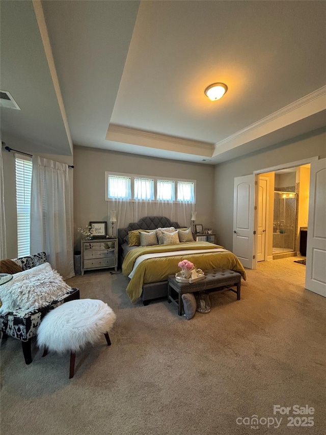 bedroom with a raised ceiling, carpet, and visible vents