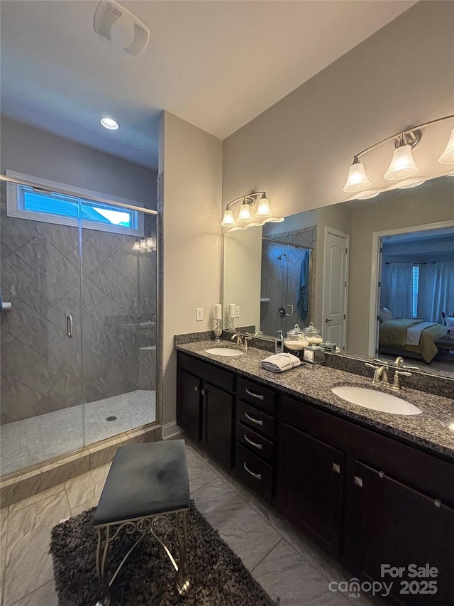 ensuite bathroom with a stall shower, ensuite bathroom, double vanity, and a sink