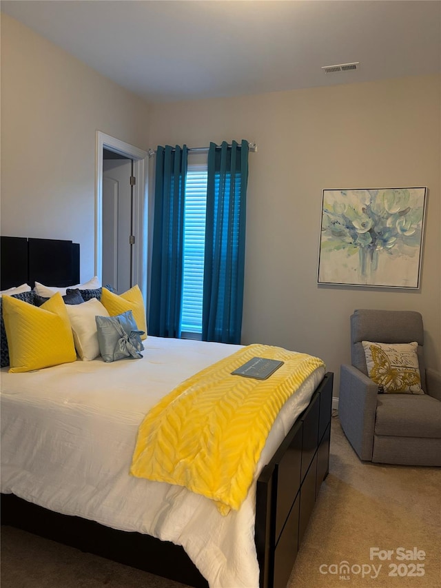 bedroom featuring light colored carpet and visible vents
