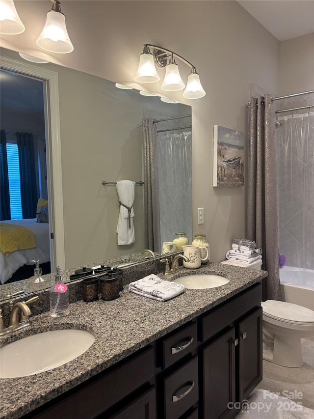 ensuite bathroom featuring a sink, double vanity, ensuite bathroom, and tile patterned flooring