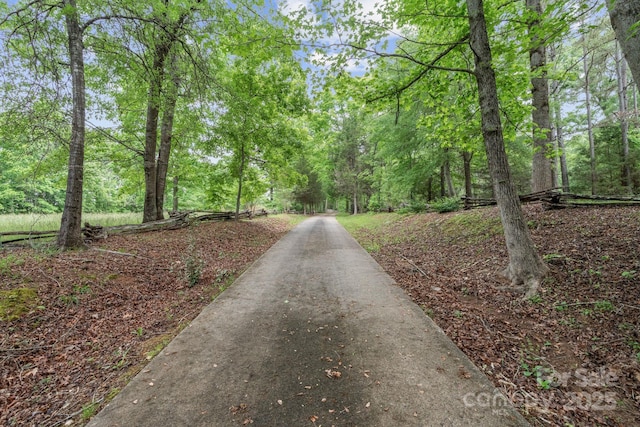 view of street featuring a forest view
