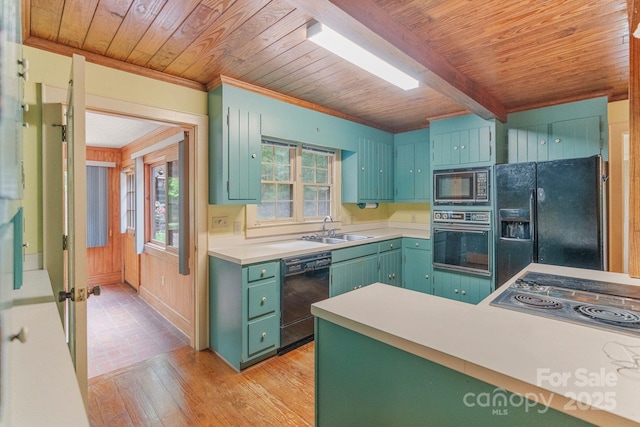 kitchen featuring light countertops, wood ceiling, black appliances, and a sink
