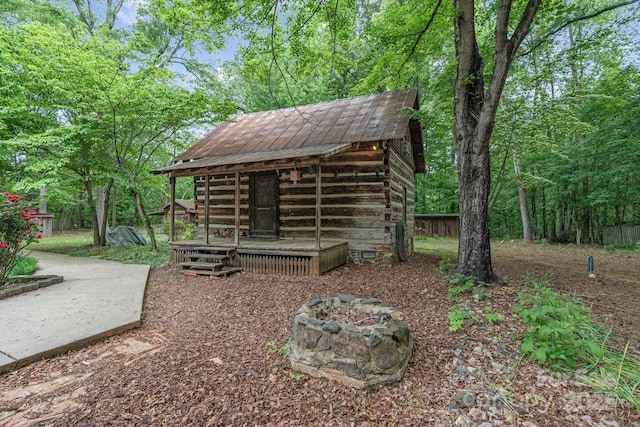 view of yard featuring a fire pit and an outdoor structure