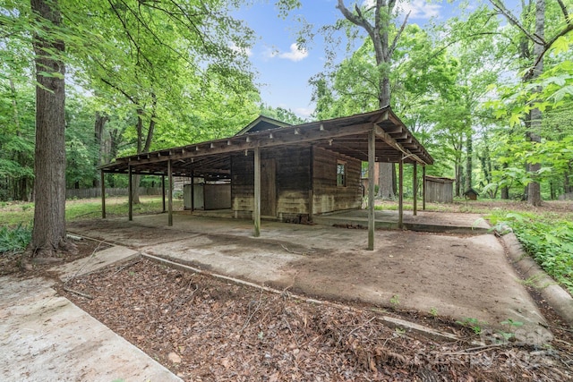 view of property's community featuring fence and a carport