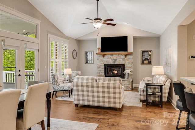 75 Balsam High Rd, Biltmore Lake, NC 28715 - living area featuring wood finished floors, lofted ceiling, a stone fireplace, ceiling fan, and baseboards